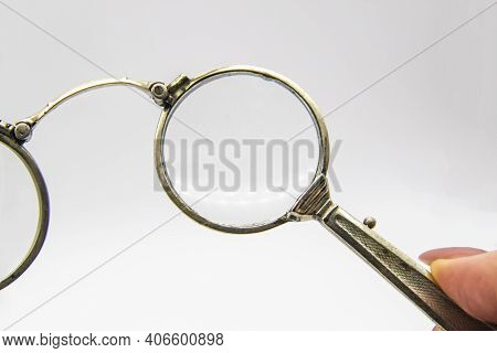 Hand Hold An Old Vintage Lorgnette From The Middle Of The Nineteenth Century On The White Background