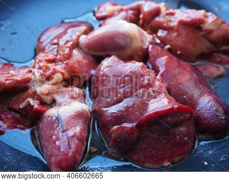 Chicken Liver, Kidney And Heart In A Non-stick Skillet. The Offal Of The Bird Is Placed In A Dark Bo