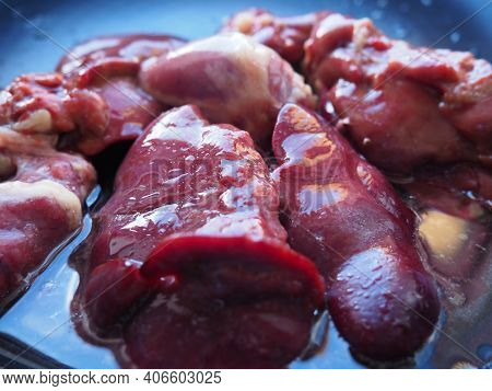 Chicken Liver, Kidney And Heart In A Non-stick Skillet. The Offal Of The Bird Is Placed In A Dark Bo