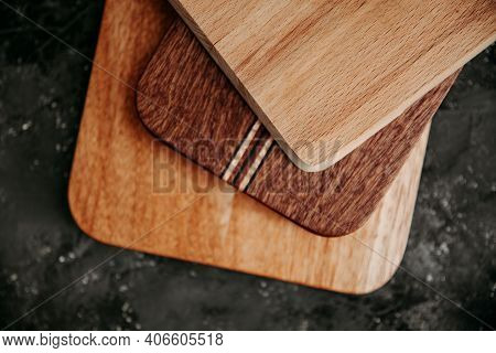 Set Of Wooden Cuttng Boads On Black Background. Wooden Kitchen Block Close Up.
