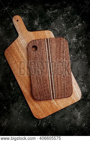 Set Of Wooden Cuttng Boads On Black Background. Wooden Kitchen Block Close Up.