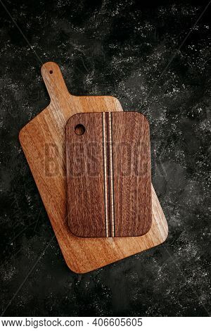 Set Of Wooden Cuttng Boads On Black Background. Wooden Kitchen Block Close Up.