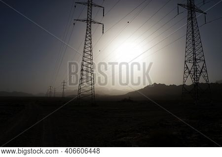 Sand Storm In The Desert Near Eilat Upon Power Line Supports