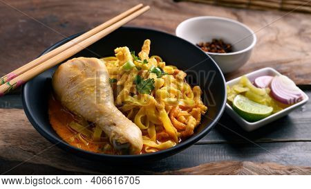 Northern Thai Food (khao Soi), Spicy Curry Noodles Soup With Chicken Eating With Crispy Deep-fried E