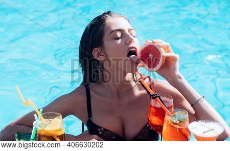 Sensual Girl. Young Woman Reaxing In Swimming Pool At Exotic Resort