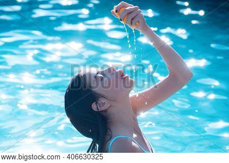 Young Woman With Orange Juice In Beach Bar. Sensual Girl. Young Woman Reaxing In Swimming Pool At Ex
