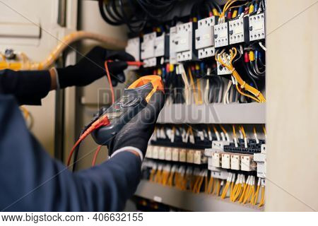Electrician Engineer Work Tester Measuring Voltage And Current Of Power Electric Line In Electical C