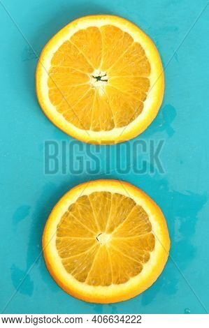 Close Up Of Two Round Orange Citrus Slices On Blue Background, Fresh Summer Mood. Stock Photo Blank 