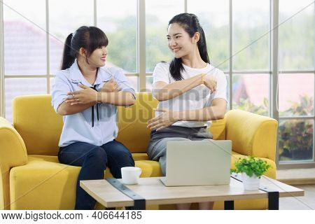 The Sign Language Instructor Teaching A Beautiful Woman To Learn Deaf Language.