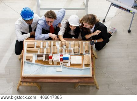 Image Is Topview. A Man African American Engineering And Caucasian Holds Coffee. In Group Meetings V