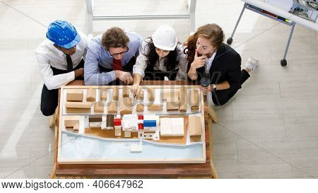 Image Is Topview. A Man African American Engineering And Caucasian Holds Coffee. In Group Meetings V