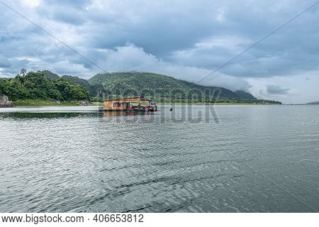 Beautiful Nature Scenic Landscape With Mountain Range Clear View On Blue Sky And Wooden Raft Floatin