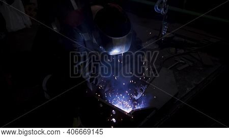 A Laborious Worker In A Uniform And A Protection Mask During Welding Process. Clip. Welder In A Work