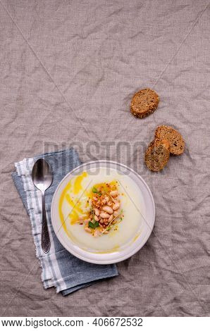 Vegetable Cream Soup With Beans And Spicy Oil In A Bowl On A Textile Background. Selective Focus.