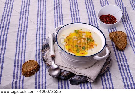 Vegetable Cream Soup With Beans And Spicy Oil In A Bowl On A Textile Background. Selective Focus.