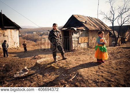 Serednie, Ukraine - March 09, 2011: Older Romani Children Help Parents Raise Younger Siblings