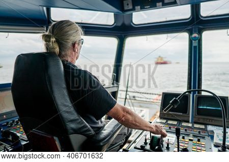 Captain Of Deck Officer On Bridge Of Vessel Or Ship During Navigaton Watch At Sea