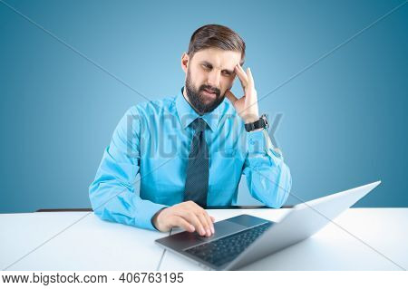 A Bearded Businessman At A Laptop Leaned His Hand To His Head He Has Severe Headaches, A Man Sitting