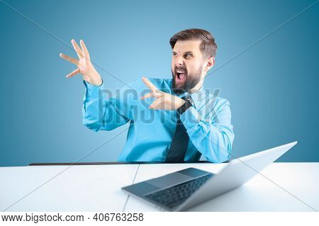 The Bearded Businessman At The Computer Opened His Mouth And Gestured With His Hands To The Side