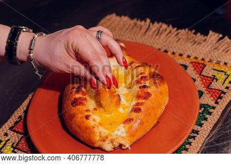Woman Is Eating Adjarian Khachapuri With Hands, Crushing Egg Yolk.