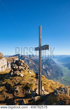 Summit Cross From Churfirsten Zuestoll With A Beautiful View Of The Valley And The Small Village Of 