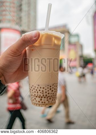 Close Up Bubble Tea In The Hand Of Tourist On Walking Street In China
