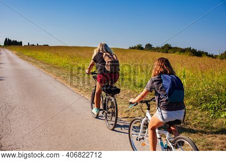 Mother And Daughter Cyclists Riding In The Countryside Track Of Strunjan, Slovenia