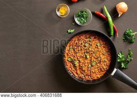Keema Curry In Frying Pan Over Dark Background With Free Text Space. Indian And Pakistani Style Dish