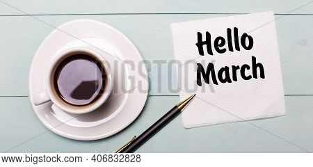 On A Light Blue Wooden Tray, There Is A White Cup Of Coffee, A Handle And A Napkin That Says Hello M