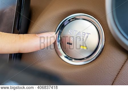 Finger Press A Car Ignition Button Or Start Engine Inside Modern Electric Automobile. Keyless, Chang