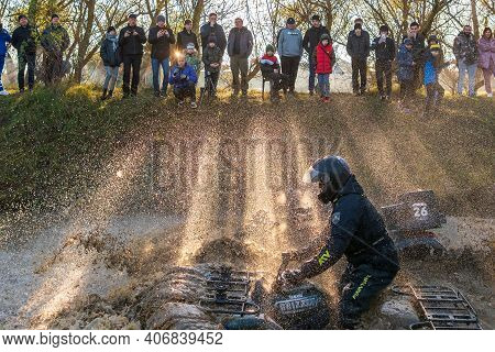 Afipsip, Russia - October 31, 2020: Sportsmen Drive Quad Bikes Splashing In Deep Water At Mud Racing