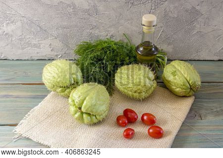 The Fruits Of Mexican, Healthy Liana (sechium Edule) Cherry Tomatoes, Dill And Olive Oil On Wooden T