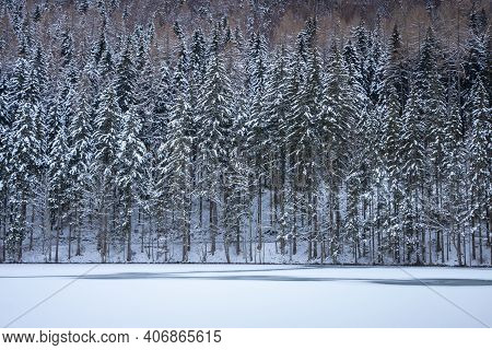 Frozen Winter Lake In The Mountains Covered With Snow. Plansar Lake, Jezersko Slovenia.