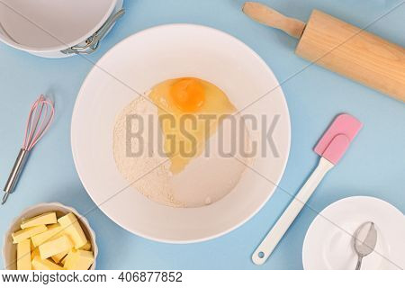 Preparing Dough For Shortcrust Cake Base With Flour, Sugar, Baking Bowder And Egg In Mixing Bowl