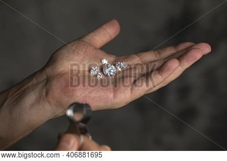 Large Polished Round Cut Diamond In Hand Close Up Front View. High Quality Photo