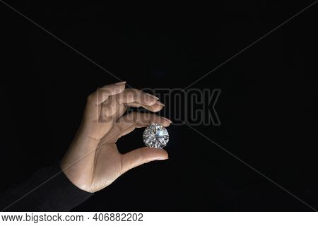 Large Polished Round Cut Diamond In Hand Close Up Front View. High Quality Photo