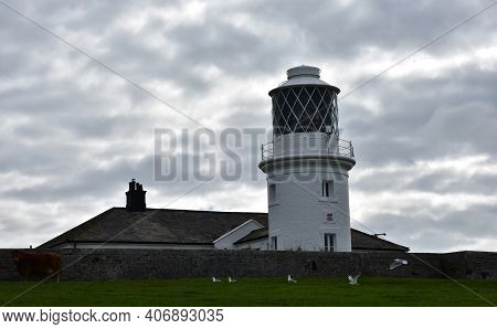 Scenic Views Of St Bees Lighthouse With Lots Of Clouds.