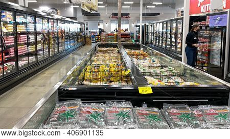 An Overview Of The Refridgerated Section Of A Bravo Market Grocery Store