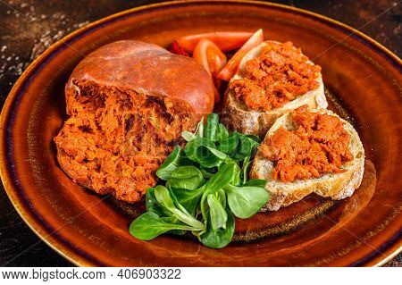Toasts With Sobrassada Cured Pork Meat Sausage And Tomato. Dark Background. Top View