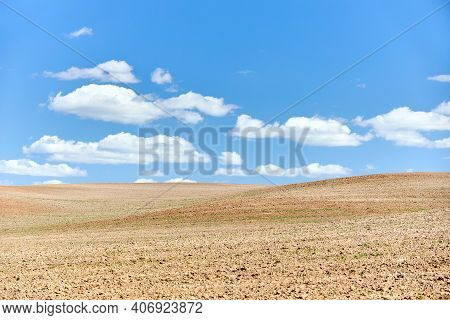 Ploughed Arable Plowing Agricultural Land Plowed For Crops Under Blue Sky With Clouds Conceptual Bac