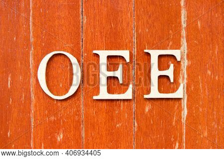 Alphabet Letter In Word Oee (abbreviation Of Overall Equipment Effectiveness) On Old Red Color Wood 