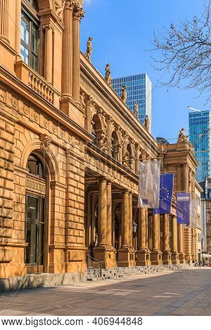 Building Of The Stock Exchange In Frankfurt With Flags Above Entrance. Brown Colored Historical Comm