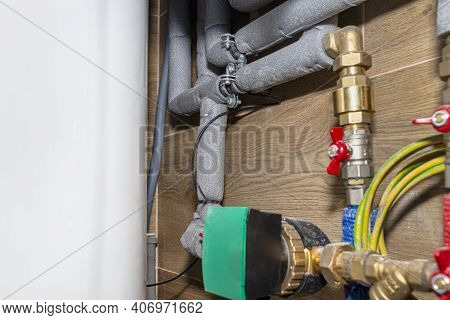 Natural Gas Valves And Pipes In A Modern Home Boiler Room With Ceramic Tiles, Visible Water Circulat