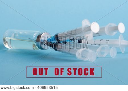 An Ampoule With Medicine And Five Syringes Stuck In The Bottle Cap, On The Background Of The Inscrip
