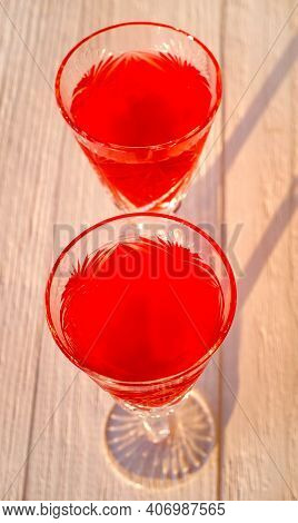Two Glasses With Red Liquor And Sunligt Effect. Abstract Background, Close-up, Selective Focus