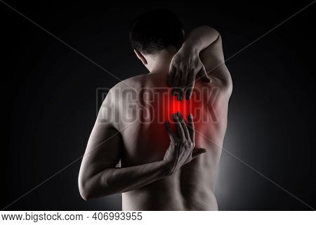 Pain Between The Shoulder Blades, Man Suffering From Backache On Black Background