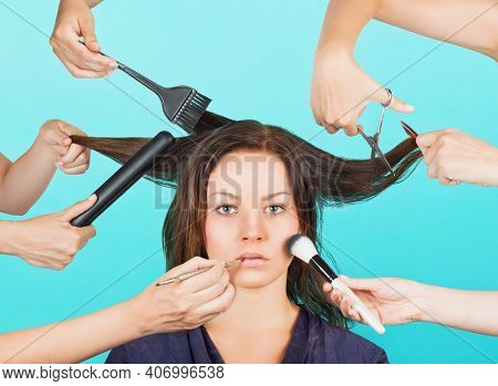 Girl Made Up And Coiffed By Many Hands. Concept Of Multitasking Makeup