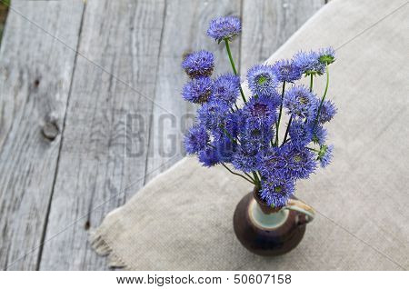 Rustic Still Life With A Bouquet Of Blue Flowers On A Wooden Background