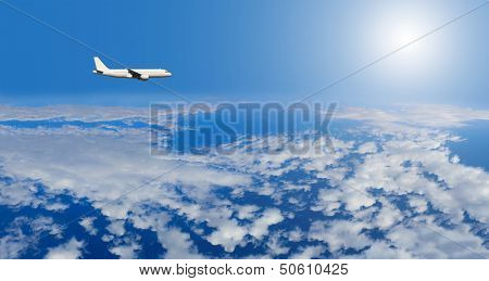 Airplane inflight in the sky above clouds