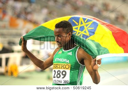 BARCELONA - JULY, 14: Muktar Edris of Ethiopia celebrates his victory on 5000 meters of the 20th World Junior Athletics Championships at the Olympic Stadium on July 14, 2012 in Barcelona, Spain